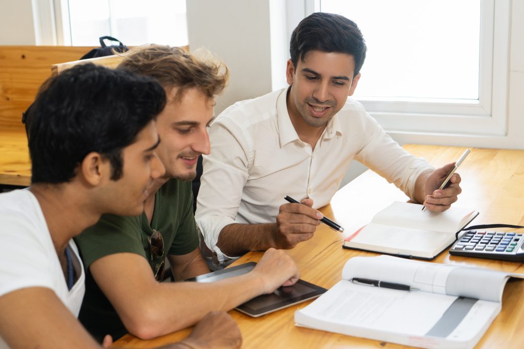 young teacher telling two students about corporate budgeting